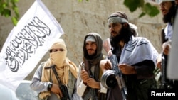 FILE - Members of the Taliban celebrate the cease-fire in Ghanikhel district of Nangarhar province, Afghanistan, June 16, 2018.