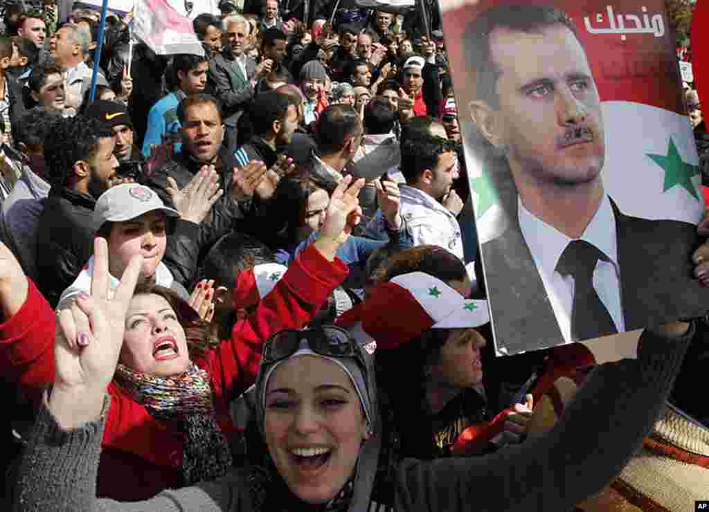 Supporters of Syrian President Bashar al-Assad attend a rally at Umayyad square in Damascus, March 15, 2012. (Reuters)