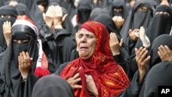 A female anti-government protestor, center, reacts while chanting prayers along with other women during a demonstration demanding the resignation of Yemeni President Ali Abdullah Saleh, in Taiz, Yemen, Friday, July 1, 2011