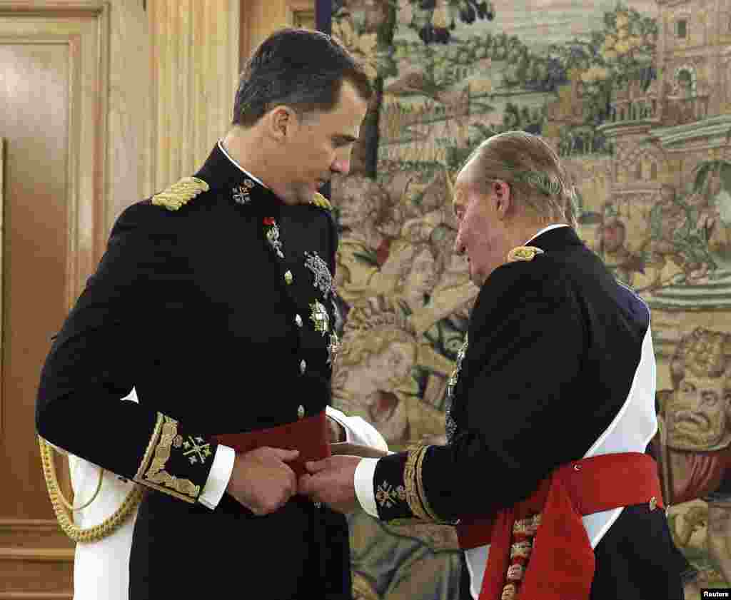 Juan Carlos I impuso el fajín de capitán general al nuevo rey Felipe VI en la Sala de Audiencias del Palacio de la Zarzuela.