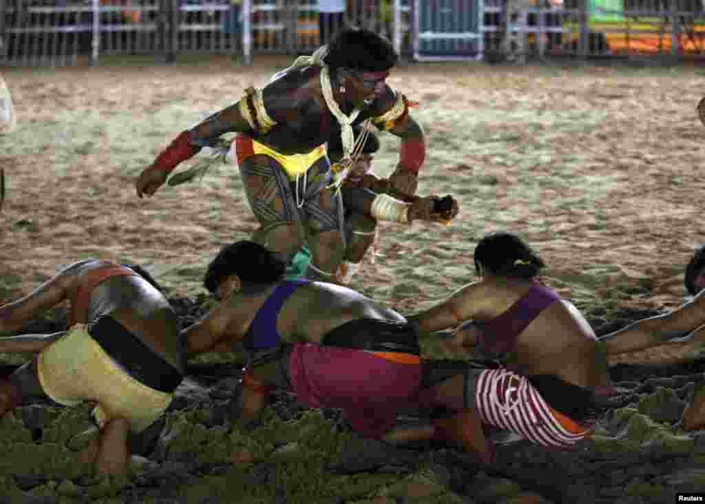 A member of the Brazilian indigenous ethnic group Enawene-Awe reacts as they compete in a tug-of-war competition during the XII Games of the Indigenous People, in Cuiaba, Brazil, Nov. 14, 2013.