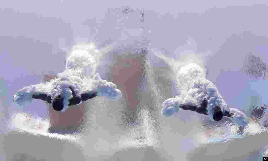 Jeinkler Aguirre and Jose Guerra of Cuba compete in the men's 10-meter synchro platform preliminary competition at the FINA Swimming World Championships in Barcelona, Spain.