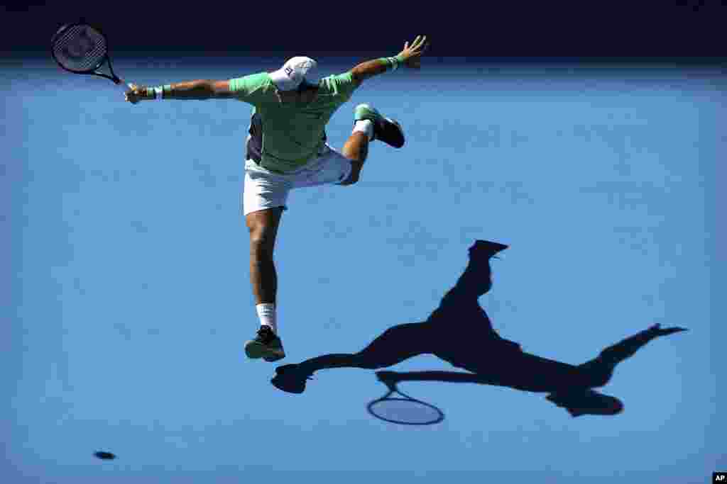 Dusan Lajovic of Serbia returns a shot while competing against Grigor Dimitrov of Bulgaria in the China Open at the National Tennis Stadium in Beijing.