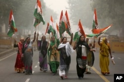 India's main opposition Congress party supporters shout slogans as they arrive to join a protest on the first anniversary of the demonetization announcement, in New Delhi, India, Wednesday, Nov. 8, 2017.