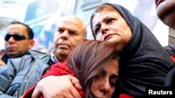 The mother, right, of photographer Nadhir Ktari, who disappeared with fellow journalist Sofiene Chourabi in Libya in September, attends a demonstration held in solidarity with the missing pair in Tunis, Jan. 9, 2015.