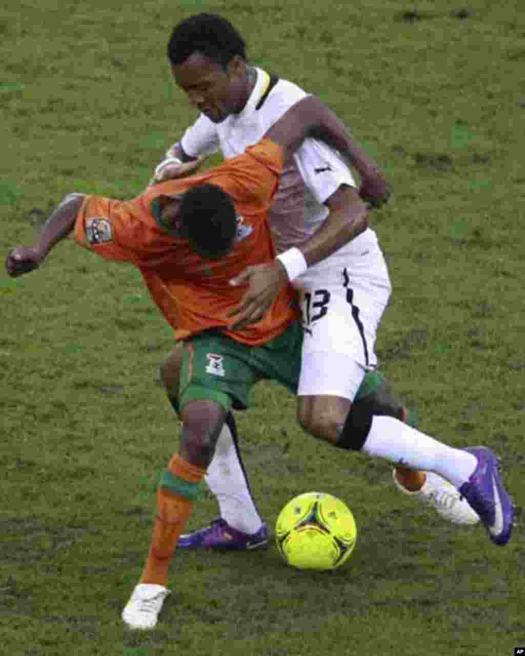 Jordan Ayew of Ghana (R) fights for the ball with Rainford Kalaba of Zambia during their African Nations Cup semi-final soccer match at Estadio de Bata "Bata Stadium" in Bata February 8, 2012.
