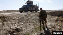 FILE - An Afghan National Army (ANA) soldier searches for mines during a patrol in Logar province, Afghanistan February 16, 2016.