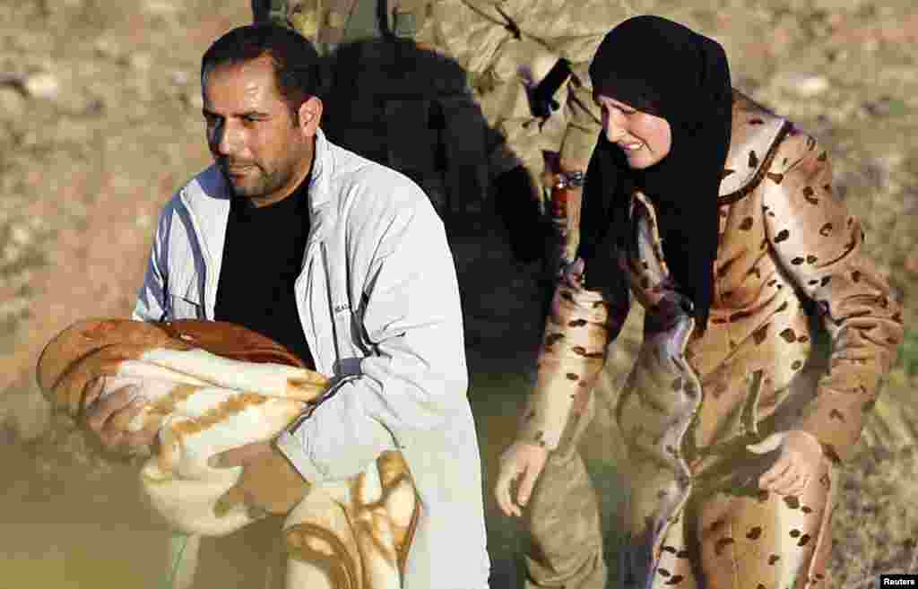 A Syrian family is pictured after they crossed the border fences in the Turkish border town of Ceylanpinar, Sanliurfa province November 12, 2012. 