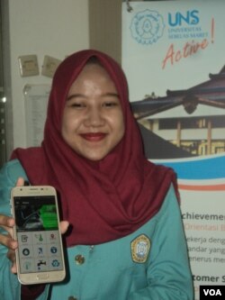 Mahasiswi Teknik eletro UNS Solo memamerkan aplikasi sistem air bersih buatannya dari smartphonenya. (Foto: VOA/Yudha)