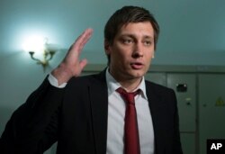 FILE - Russian opposition lawmaker Dmitry Gudkov speaks to the media in Moscow, Russia, March 14, 2013.