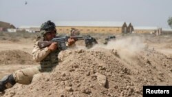 Iraqi soldiers train with members of the U.S. Army 3rd Brigade Combat Team, 82nd Airborne Division, at Camp Taji, Iraq, in this U.S. Army photo released June 2, 2015. 