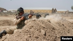 FILE - Iraqi soldiers train with members of the U.S. Army 3rd Brigade Combat Team, 82nd Airborne Division, at Camp Taji, Iraq, in this U.S. Army photo released June 2, 2015. 