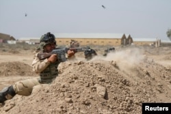 FILE - Iraqi soldiers train with members of the U.S. Army 3rd Brigade Combat Team, 82nd Airborne Division, at Camp Taji, Iraq, in this U.S. Army photo released June 2, 2015.