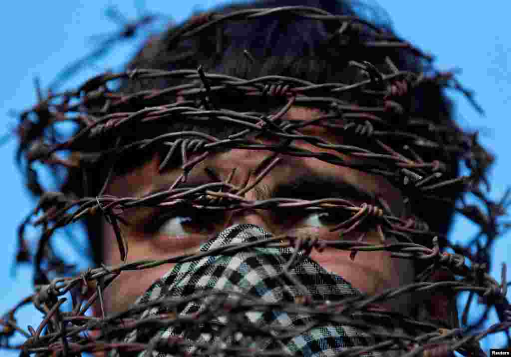 A masked Kashmiri man attends a protest after Friday prayers during restrictions following the scrapping of the special constitutional status for Kashmir by the Indian government, in Srinagar.