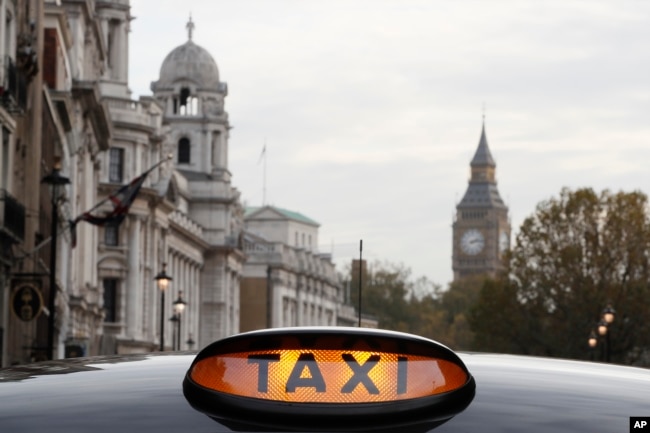 A taxi sign is lit up on a vehicle in London, Nov. 8, 2016.