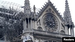 Firefighters work at Notre-Dame Cathedral in Paris, France April 16, 2019. A massive fire consumed the cathedral on Monday, gutting its roof and stunning France and the world. REUTERS/Yves Herman