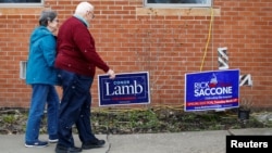 A couple arrive at a polling place in Carnegie, Pennsylvania, March 13, 2018. 