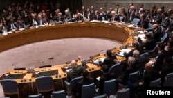 Members of the United Nations Security Council vote unanimously to approve a resolution eradicating Syria's chemical arsenal at a meeting during the 68th United Nations General Assembly in New York on Sep. 27, 2013. 