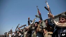 FILE - Tribesmen loyal to Houthi rebels hold their weapons and chant slogans during a gathering aimed at mobilizing more fighters into battlefronts in several Yemeni cities in Sana'a, Oct. 2, 2016. 