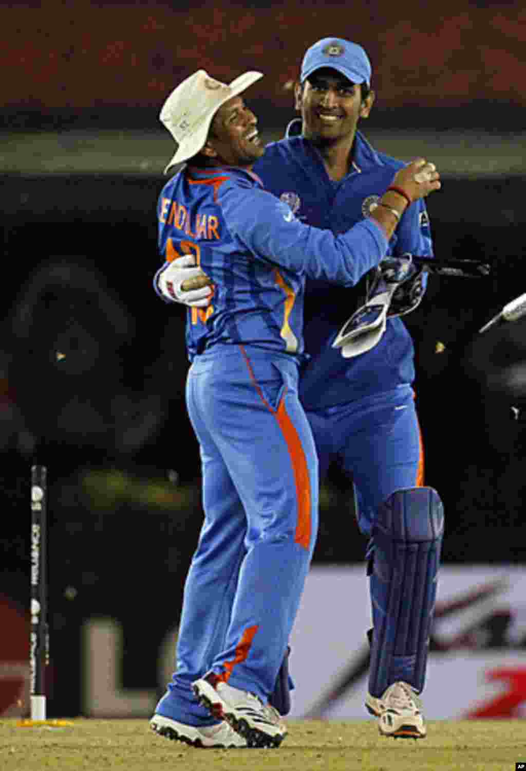 India's Sachin Tendulkar (L) hugs captain and wicketkeeper Mahendra Singh Dhoni after India won their ICC Cricket World Cup 2011 semi-final match against Pakistan in Mohali, March 30, 2011.