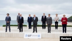 Global leaders pose for a group photo at the G-7 summit, in Carbis Bay, Britain.