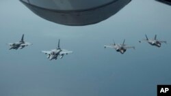 FILE - In this May 29, 2019, photo, released by the U.S. Air Force, United Arab Emirates Air Force Desert Falcons fly in formation with U.S. F-35A Lightning IIs in an undisclosed location in Southwest Asia.
