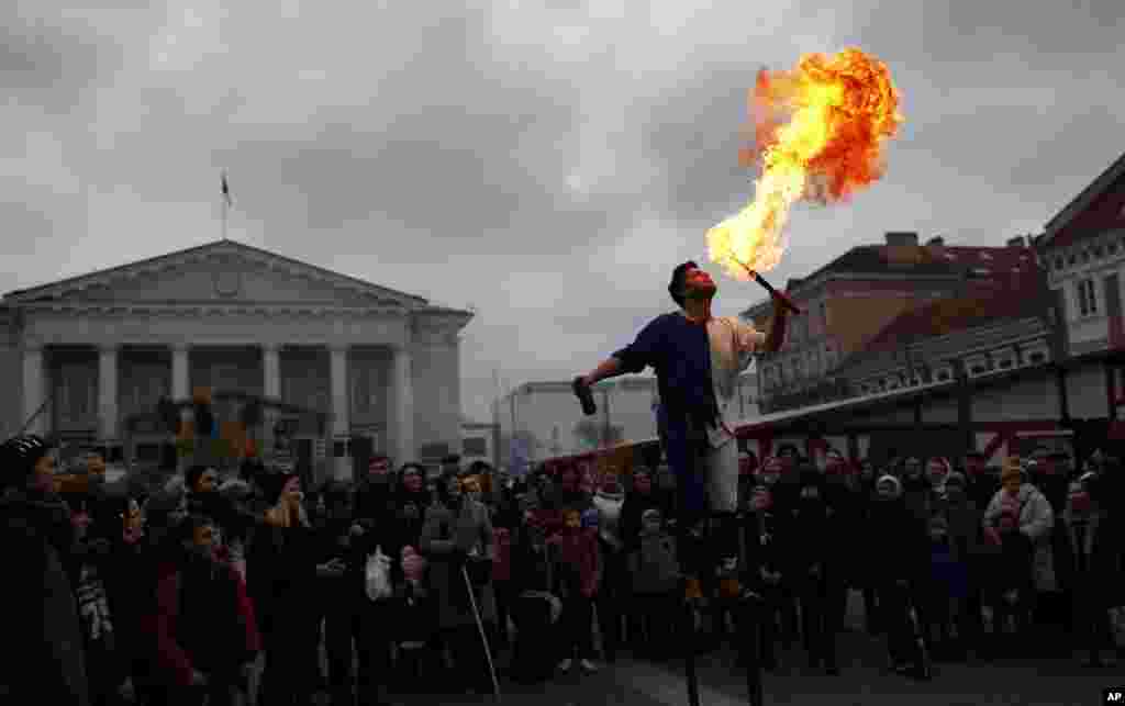 People watch a circus performance during the traditional Kaziukas fair, a large annual folk arts and craft fair in Vilnius, Lithuania, Mar. 7, 2014. 