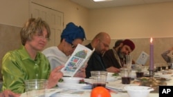 Andrea Barron (left) and Rizwan Jaka (second from right) join others in reading from the Haggadah, a Jewish text which outlines the order of the Passover Seder.
