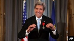 U.S. Secretary of State John Kerry smiles before delivering his speech after being awarded of the Legion d'Honneur medal, at the Quai d'Orsay, in Paris, Dec. 10, 2016. The Foreign Ministry said he earned the distinction“for his contribution of the development of relations between France and the United States, and his indefatigable efforts in favor of peace in the world.”