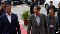 Cambodian Prime Minister and President of Cambodian People's Party, CPP, Hun Sen, center, his party Deputy Presidents, Say Chhum, right, and Sar Kheng arrive for their party's congress in Phnom Penh, Cambodia, Friday, Jan. 19, 2018. CPP on Friday began its 3-day congress in Phnom Penh. (AP Photo/Heng Sinith)