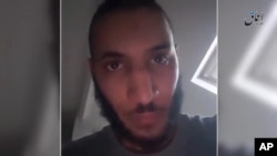 This is a still taken from video released Tuesday June 14, 2015 by Islamic State's Amaq news agency that it says is a video showing Larossi Abballa the suspect in the knifing of a French police couple confessing to the killings.