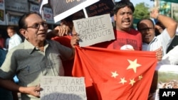 Indian citizens shout anti-Chinese slogans during a protest to boycott Chinese products in Ahmedabad on May 3, 2013.