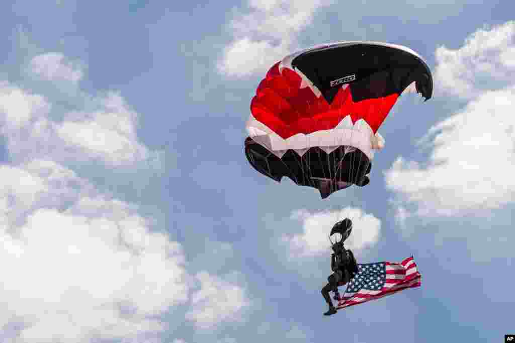 A member of the NATO parachute demonstration team lands during a change of command ceremony at NATO military headquarters in Mons, southern Belgium.