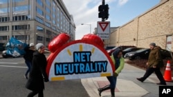 Manifestantes que apoyan la "neutralidad en la red" protestan frente a la sede de la Comisión Federal de Comunicaciones en Washington, el 14 de diciembre.