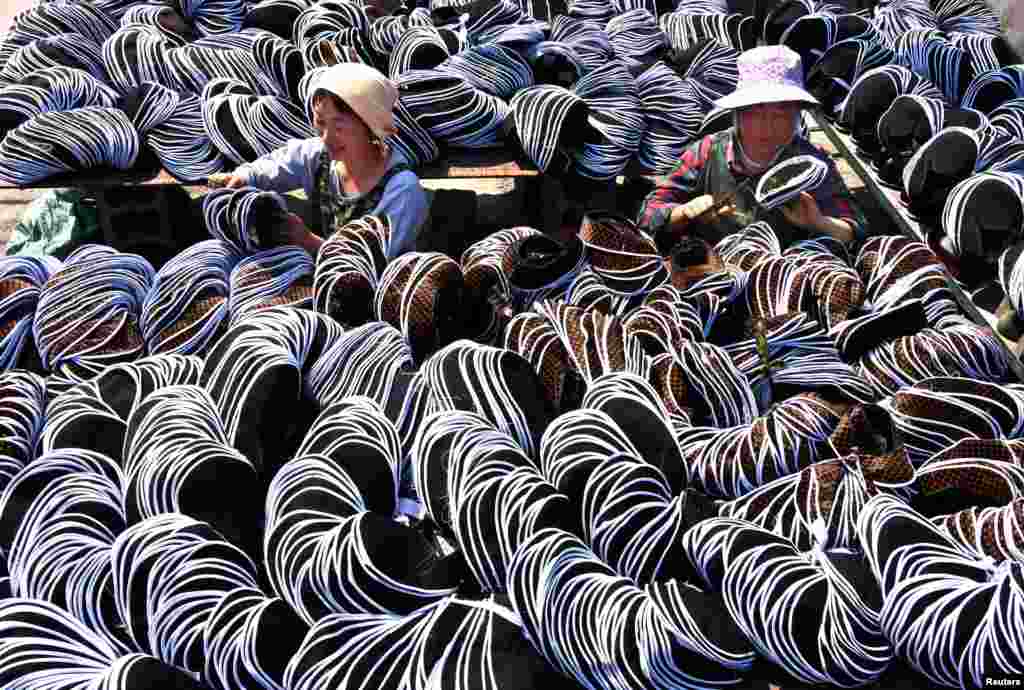 Employees work on traditional cloth shoes in Yiyuan County, Shandong province, China, May 2, 2017.