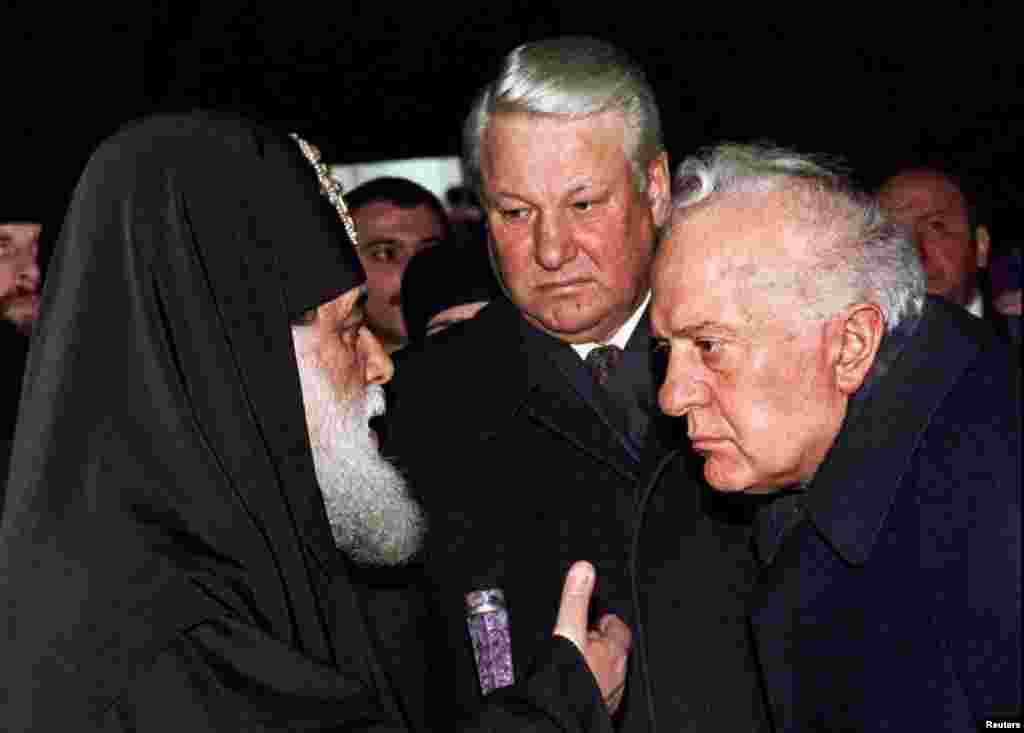 Georgian Leader Eduard Shevardnadze and visiting Russian President Boris Yeltsin listen to Georgian Katolikos Patriarch Ilia ll in a Patriarch's church in Tbilisi, Feb. 03, 1994.