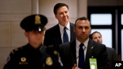 FBI Director James Comey arrives to testify on Capitol Hill in Washington, Dec. 10, 2015. On Thursday, Comey will answer question about why no criminal charges were recommended against Hillary Clinton over her use of a private email server while secretary of state.