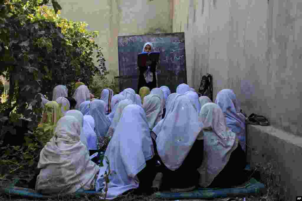 Afghan students attend an open air class at a primary school in Kabul.