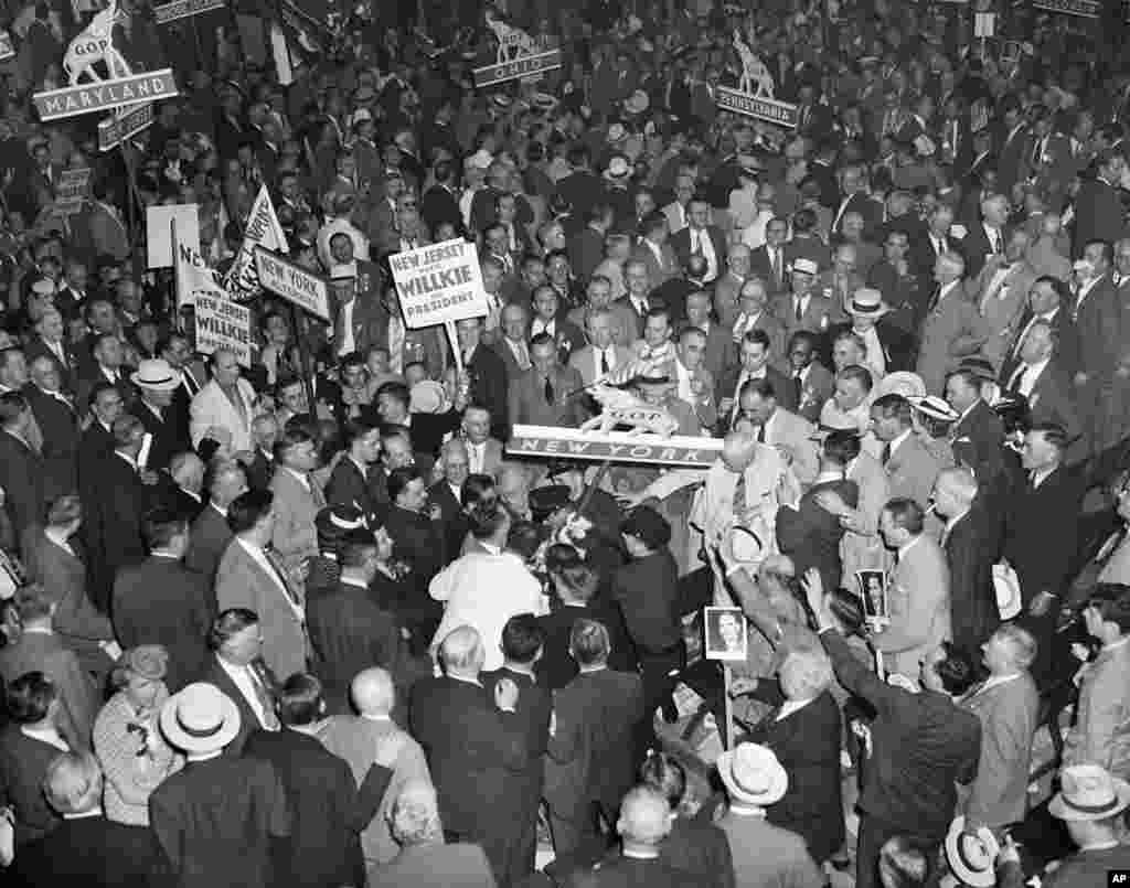 FILE - Thomas Dewey and Wendell Willkie supporters in the New York delegation attempt to seize the New York State banner at the Republican National Convention in Philadelphia, June 26, 1940. The scene followed the nomination of Willkie for the presidency.