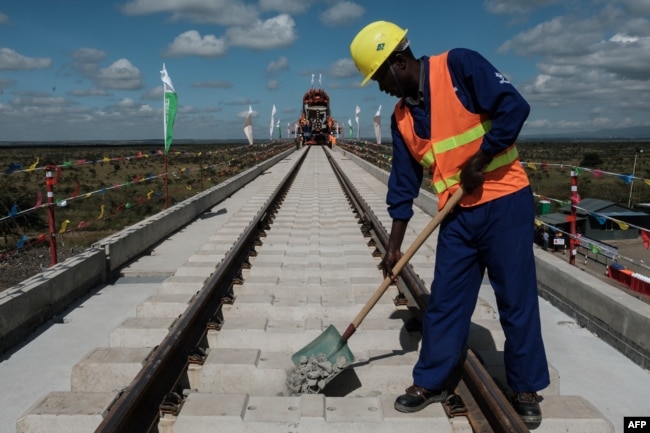 FILE - A Kenyan worker lays gravel at a construction site for the Standard Gauge Railway (SGR) in Nairobi, Kenya, June 23, 2018.