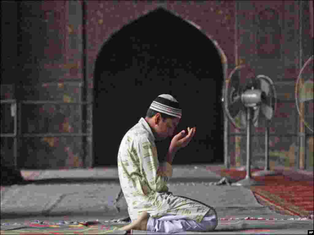 A boy says a silent prayer during the month of Ramadan at the Wazir Khan mosque in Lahore.