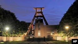 FILE - The winding tower is illuminated as a part of the European Cultural Capital Ruhr 2010 project at the former coal mine Zeche Zollverein in Essen, western Germany, June 13, 2010. 