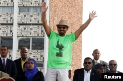 Ethiopian Prime Minister Abiy Ahmed waves to supporters as he attends a rally in Addis Ababa, Ethiopia, June 23, 2018.