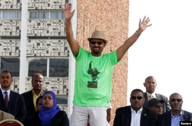 Ethiopian Prime Minister Abiy Ahmed waves to supporters as he attends a rally in Addis Ababa, Ethiopia, June 23, 2018.