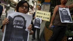 Pro-democracy protesters carry portraits of detained Chinese artist Ai Weiwei urging for his release in Hong Kong, April 10, 2011.