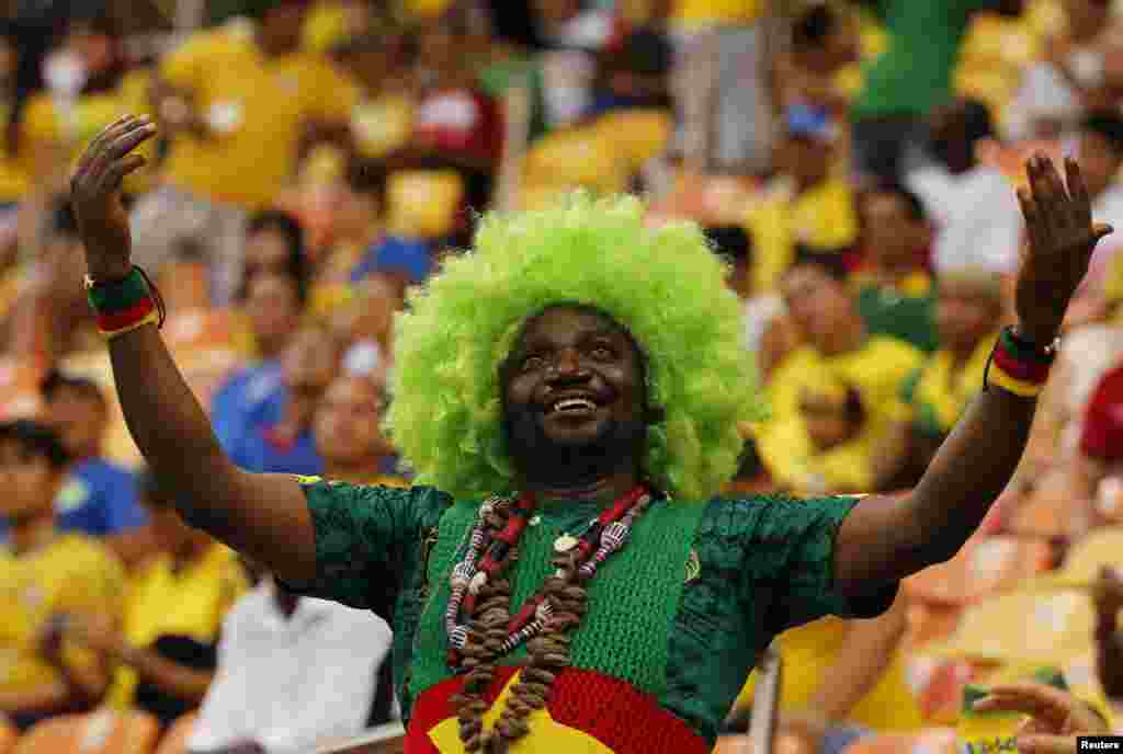 A fan of Cameroon's team cheers before their 2014 World Cup match against Croatia in Manaus, Brazil June 18, 2014.