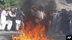 Protesters burn a US flag during a demonstration in Afghanistan's Jalalabad province, April 3, 2011, denouncing the burning last month of a copy of the Quran in a radical Florida church