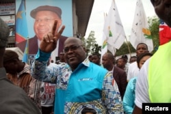 FILE - Felix Tshisekedi of the Union for Democracy and Social Progress (UDPS) gestures to supporters in the Limete Municipality of the Democratic Republic of Congo's capital Kinshasa, April 24, 2017.