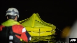 One of two life rafts dropped by an Italian navy airplane to survivors of an inflatable boat that capsized is pictured from the Dutch-flagged rescue vessel Sea-Watch 3 early on Jan. 19, 2019, off Libya's coast about 70 nautical miles north east of Tripoli.