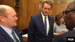 Congressmen Coons and Jeff Flake chatting with businessman Joe Mutizwa